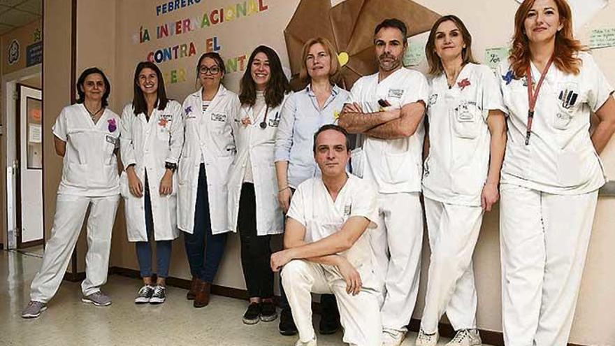 Un grupo de oncólogas y enfermeros del Materno Infantil Teresa Herrera de A Coruña, junto al mural instalado en el hospital para conmemorar del Día Internacional del Niño con Cáncer.