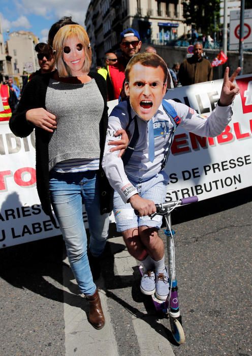 Demonstrators wearing masks depicting Emmanuel ...