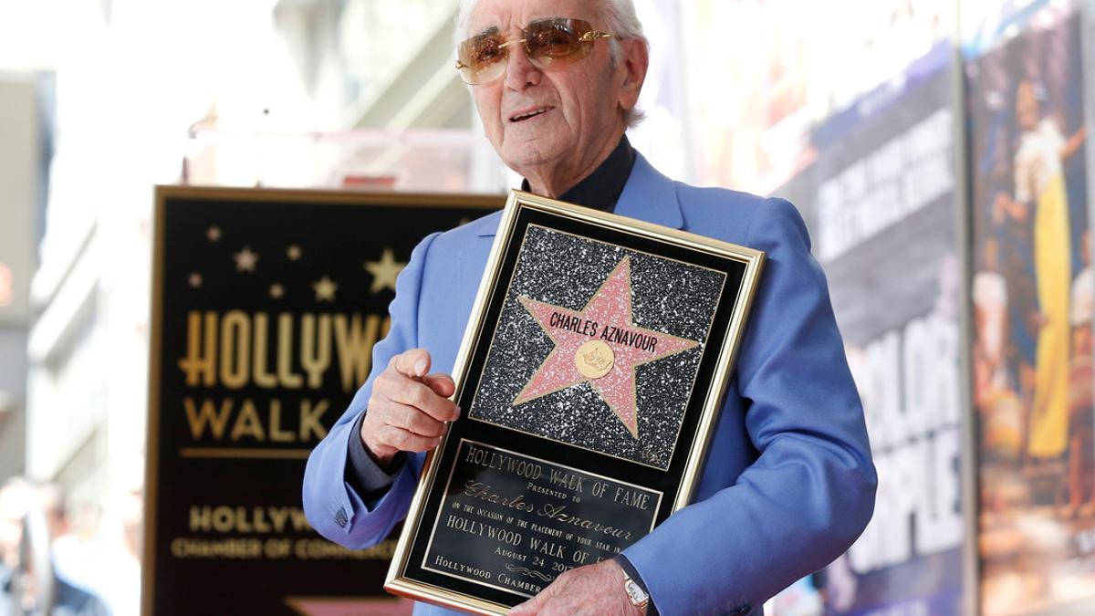 Armenian-French singer Aznavour poses after unveiling his star on the Hollywood Walk of Fame in Los Angeles