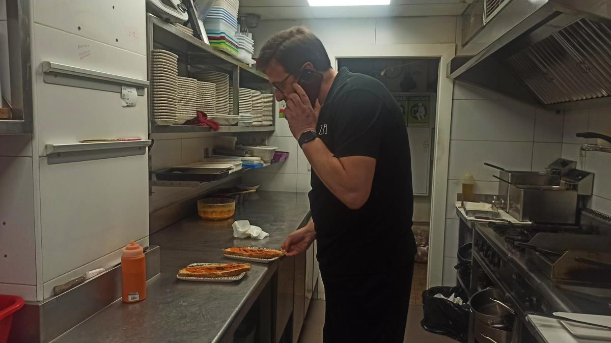 Carlos Olabuenaga, cocinero del Bar Tizona, atiende al teléfono mientras termina de preparar unas zapatillas. 