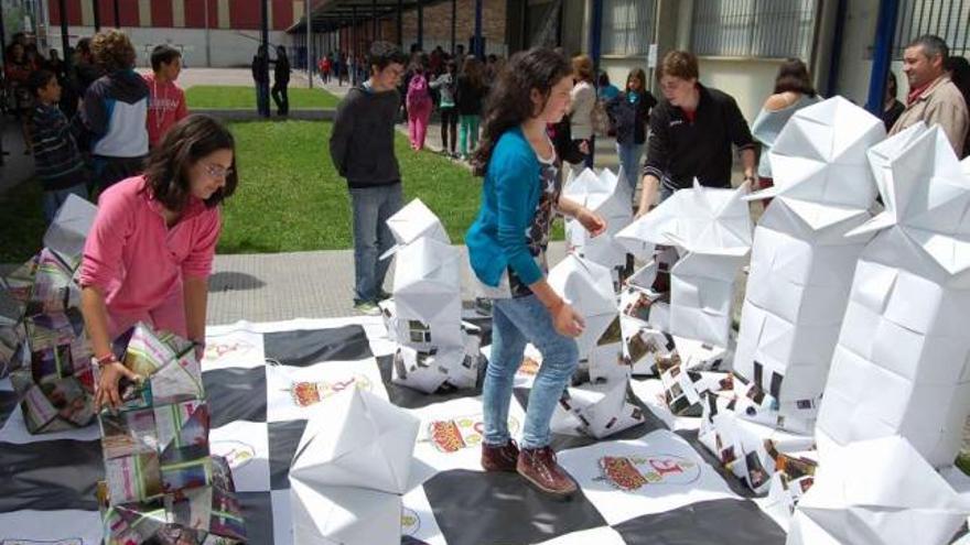 Unos alumnos juegan al ajedrez con las figuras de papel gigantes, ayer, en el instituto Pedro Floriani.  // Faro