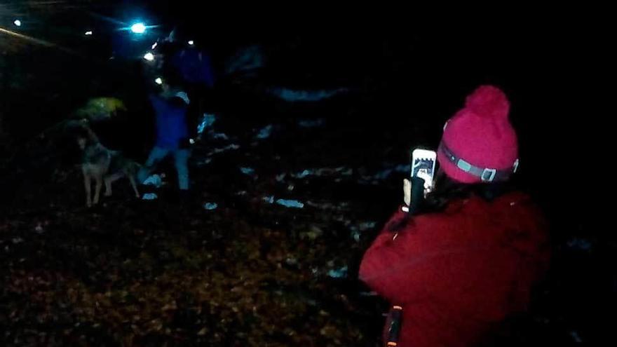 A la izquierda, la Luna, desde Campudaves. A la derecha, una participante fotografía el ascenso con un móvil.