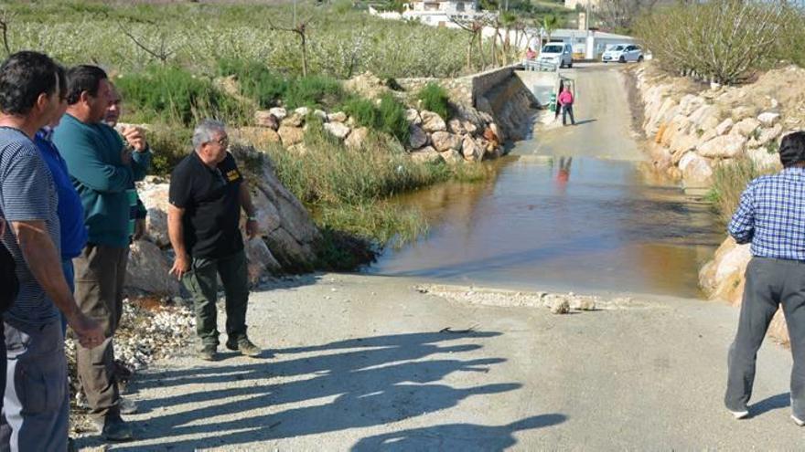 Los agricultores muestran el ´lago´ que se forma en el Camino del Olmico cada vez que llueve.