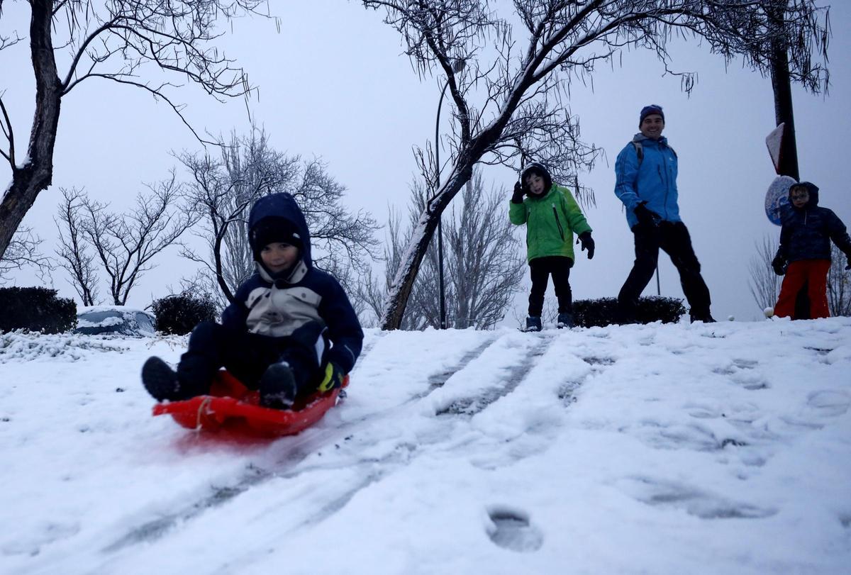 Niños jugando con la nieve ayer en Zaragoza.