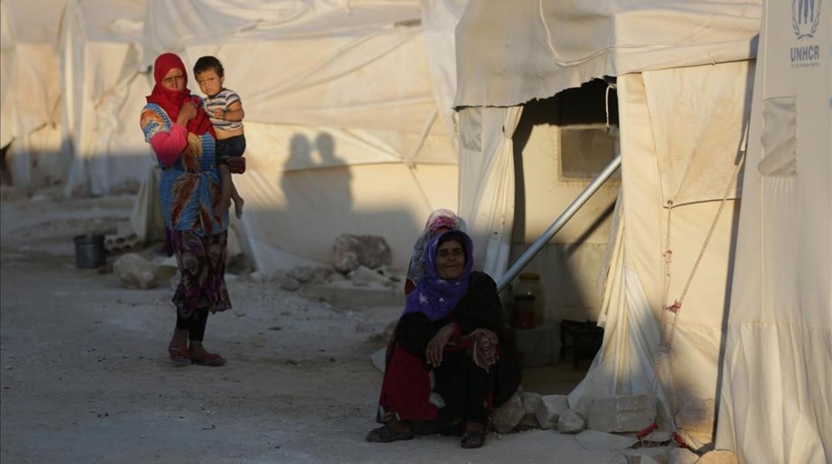 undefined44571666 internally displaced woman sits outside a tent in idlib prov180808131046