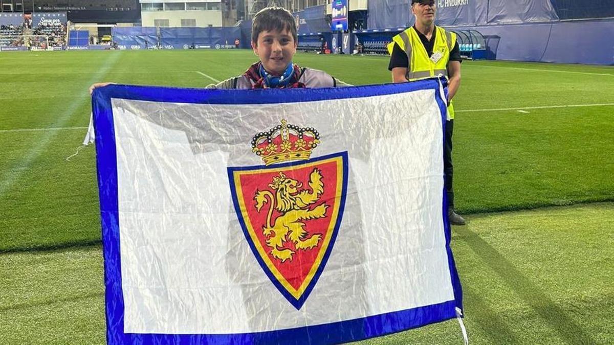 Rubén Gómez, cachirulo al cuello, muestra la bandera del Real Zaragoza que le regaló la afición.