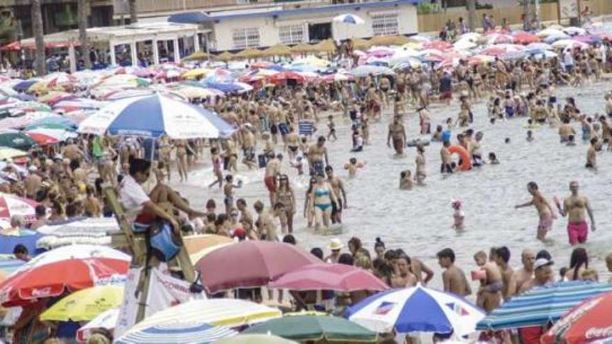 Miles de turistas llenan las playas de Torrevieja para iniciar sus vacaciones