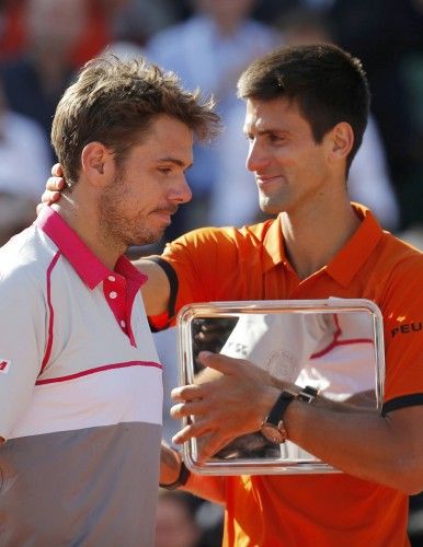 Novak Djokovic of Serbia congratulates Stan Wawrinka of Switzerland during the trophy ceremony after being defeated in their men's final match at the French Open tennis tournament at the Roland Garros stadium in Paris