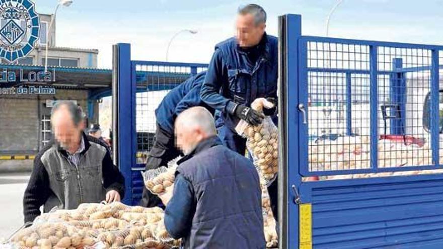 Operarios descargan los 1.400 kilos de patatas donados al Banco de Alimentos.