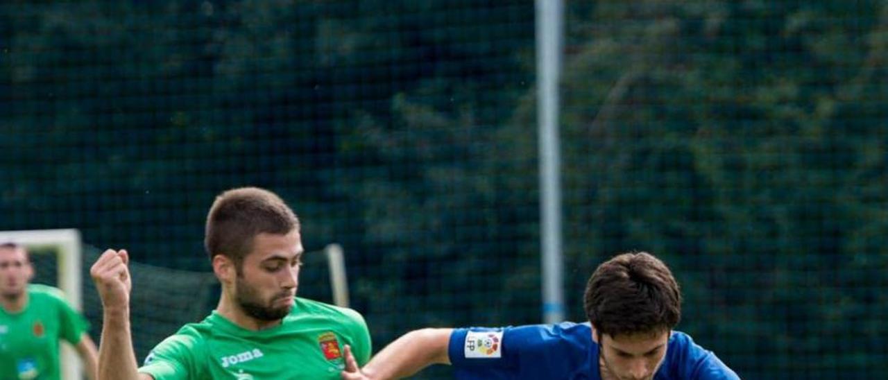 Héctor, con el balón, presionado por el jugador del Llanes Diego.