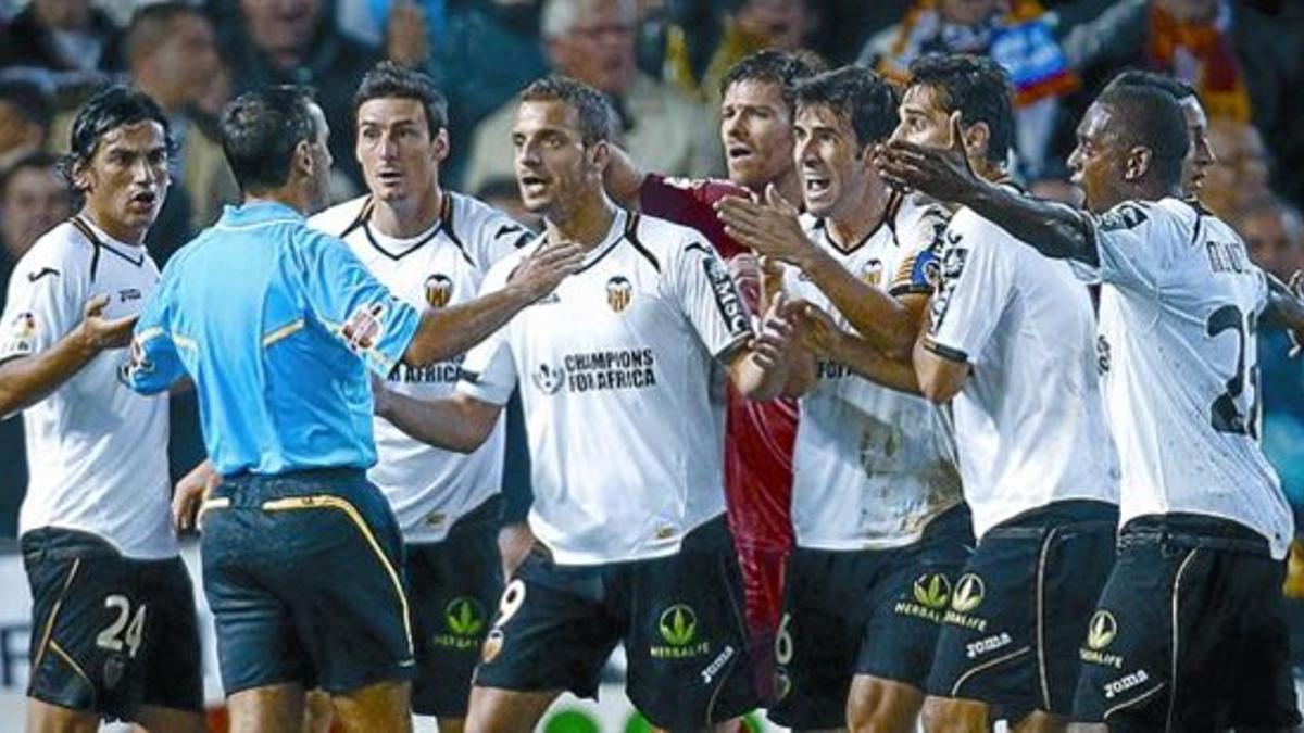 Indignados 8 Los jugadores del Valencia reclaman al árbitro que señale penalti por mano de Higuaín.