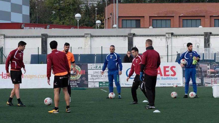 Javi Calleja y Diego García, al fondo, dirigen el entrenamiento del pasado lunes en el Hermanos Antuña.