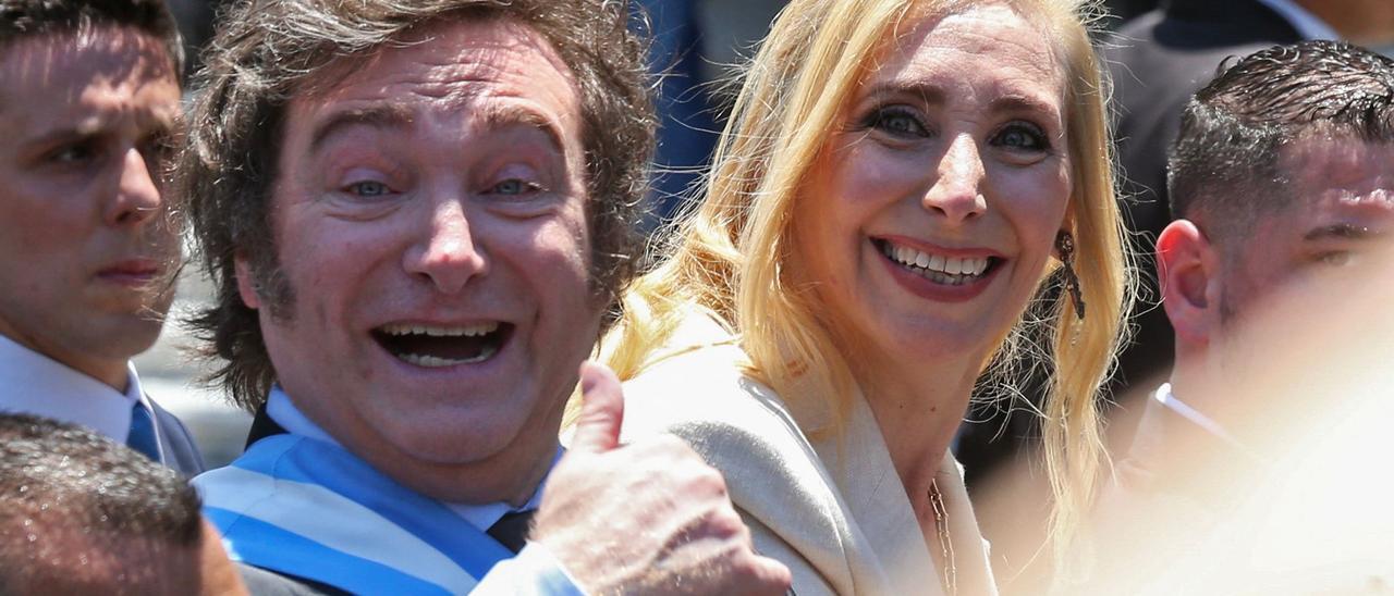 Javier Milei y Karina Milei saludan al público presente en las calles durante la investidura a la presidencia de Argentina.