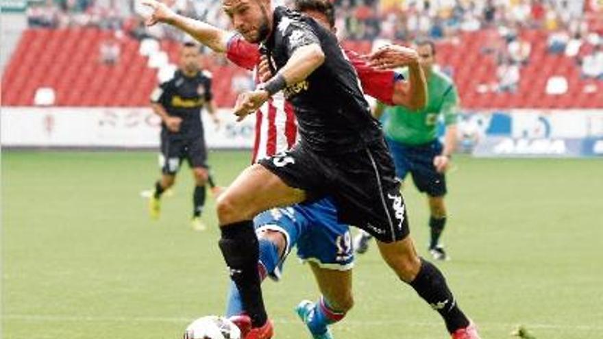 David Juncà, just en el moment de rebre una entrada del jugador de l&#039;Sporting Carlos Carmona.