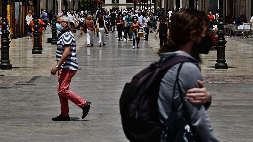 Paseantes por la calle Larios, este sábado.