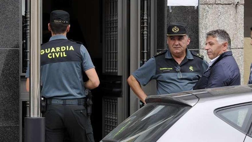 El alcalde de Silleda conversa con el capitán de la Guardia Civil junto al portal en donde reside la víctima. // Bernabé/Javier Lalín