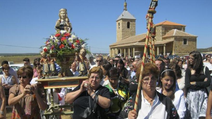 Varias mujeres llevan en andas a la Virgen del Campo.