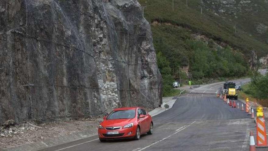 Un coche circula por el tramo cortado, al lado del talud en el que se produjo el argayo.