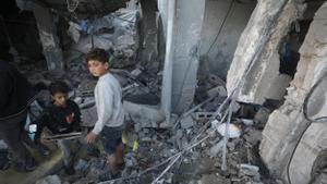 Palestinians inspect destroyed house following Israeli air strike in Deir al Balah, Gaza Strip