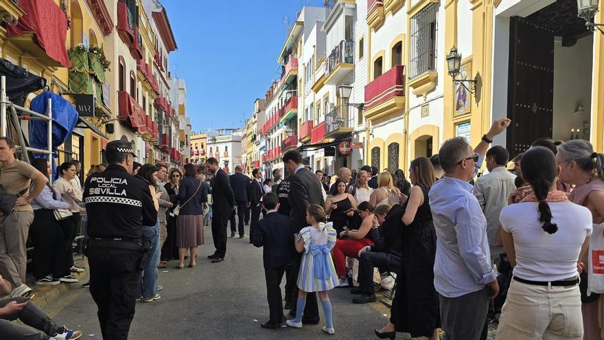 La Policía Local retira las sillitas en la calle Pureza para evitar aglomeraciones ante la salida de la Esperanza de Triana