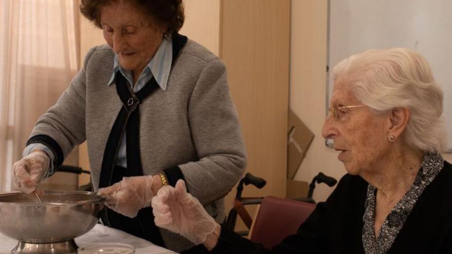 Dos residentes durante la elaboración de la receta de torrijas