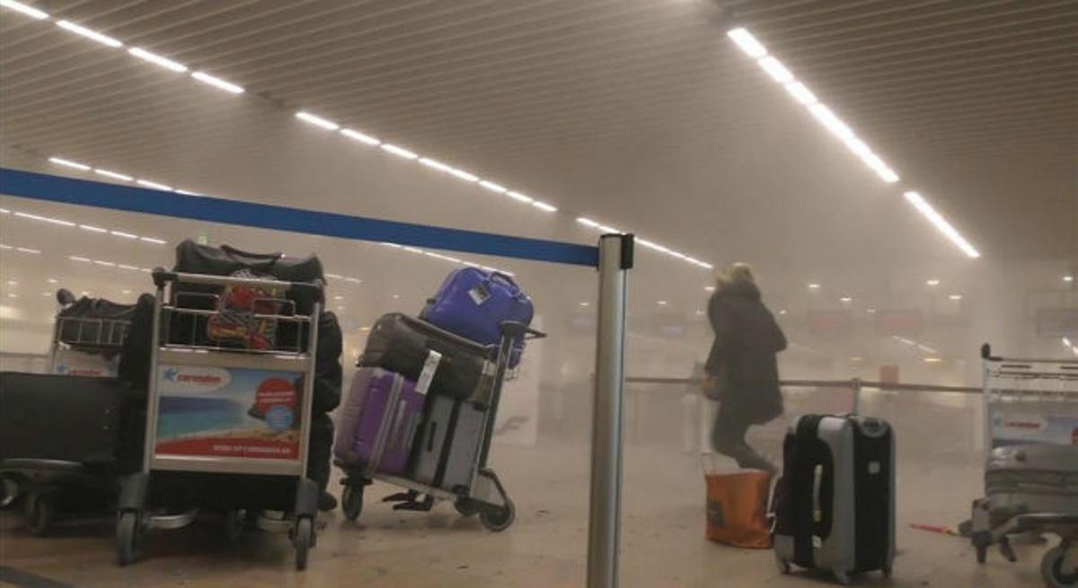 Un pasajero corre a través de los pasillos llenos de humo de la terminal del aeropuerto de Bruselas.