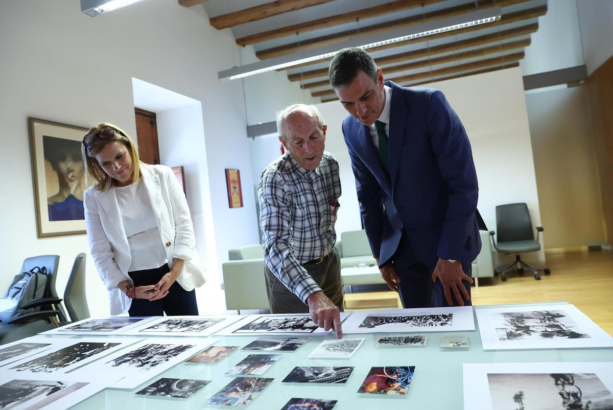El artesano muestra fotos familiares al presidente.