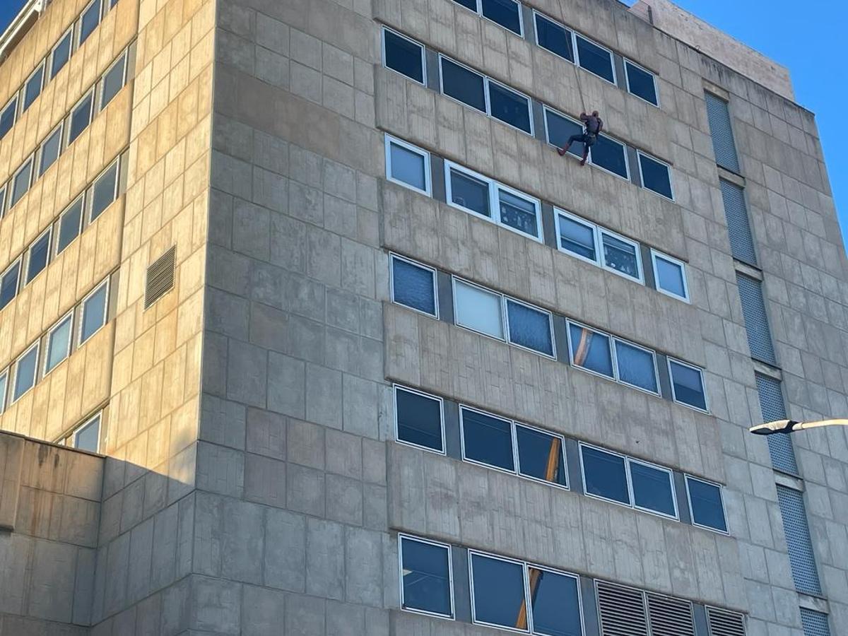 Momento del descenso de Spiderman desde la fachada del Hospital Materno de Málaga