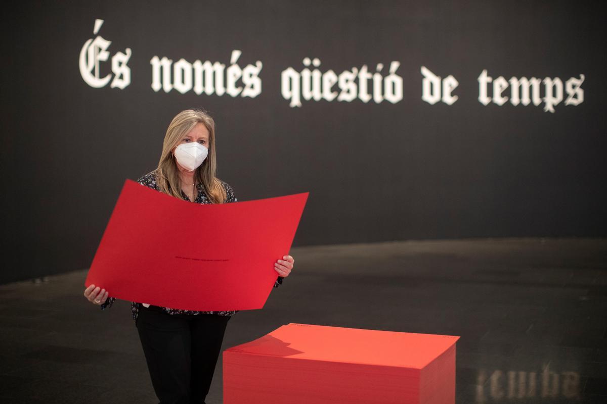 Al fondo, ‘Untitled’ It’s just a matter of time, mientras una visitante coge uno de los papeles de una de las obras de Gonzalez-Torres.