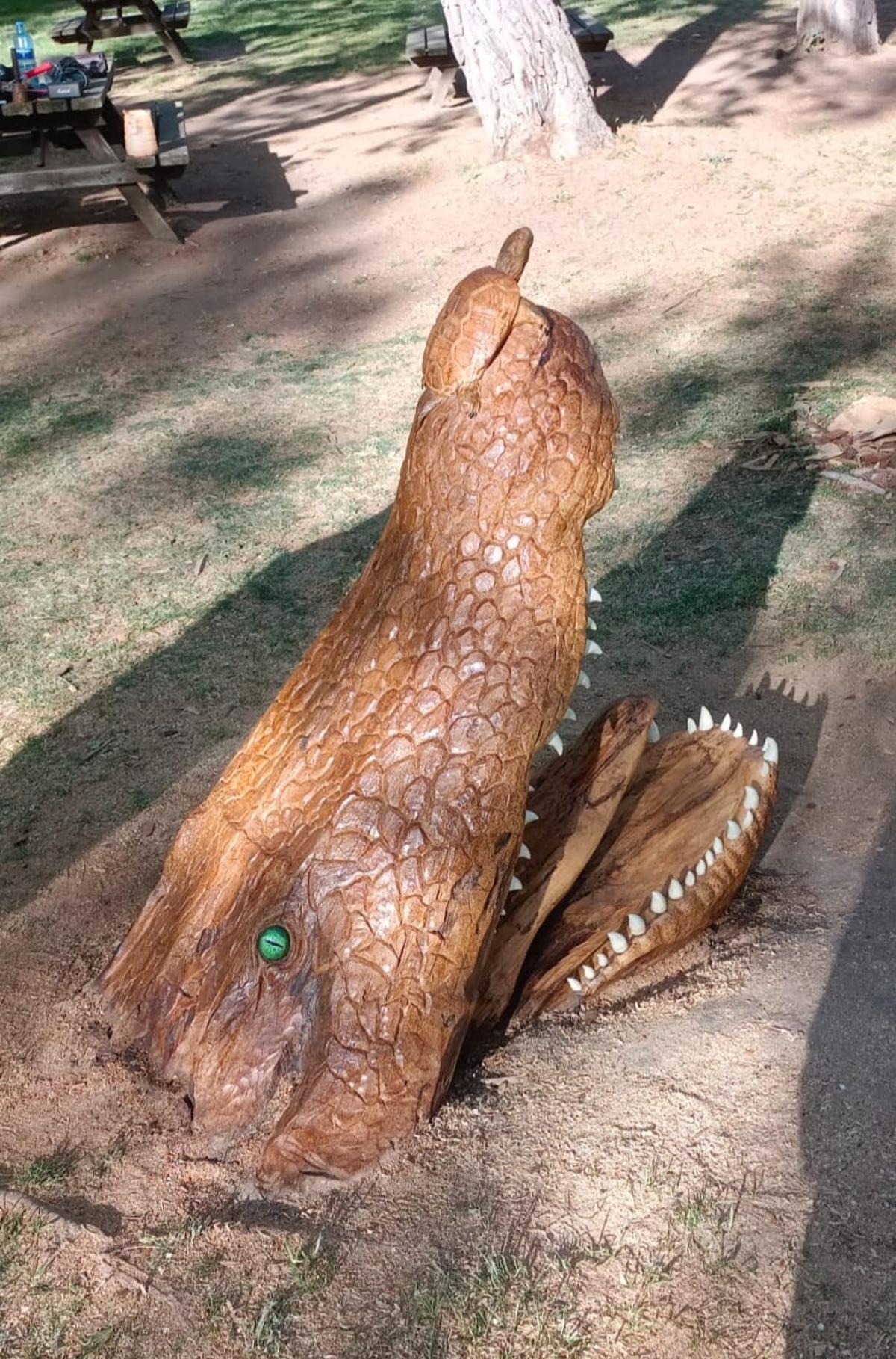 El cocodrilo y la tortuga de madera de pino, junto a un banco de Los Tres Árboles.