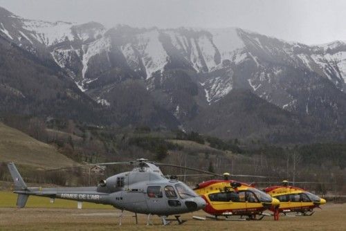 Rescue helicopters from the French Securite Civile and the Air Force are seen in front of the French Alps during a rescue operation next to the crash site of an Airbus A320