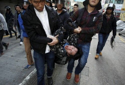 A protester shouts as he is arrested by plainclothes policemen after a clash at Mongkok district in Hong Kong