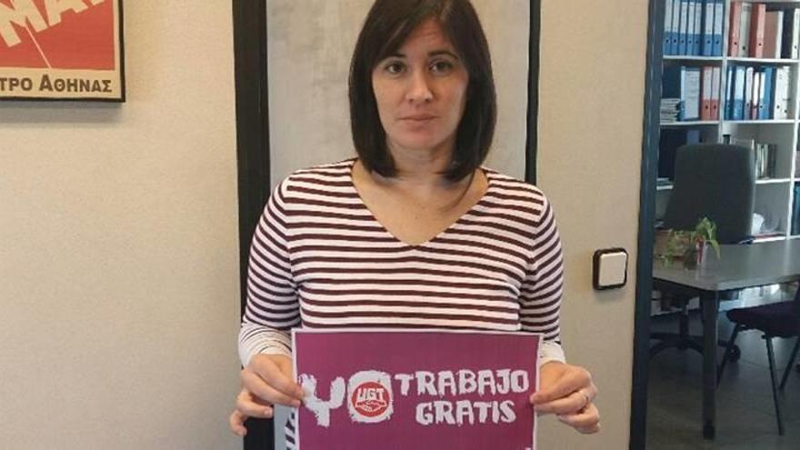 Una mujer muestra la pegatina de la campaña de UGT &#039;Yo trabajo gratis&#039; .