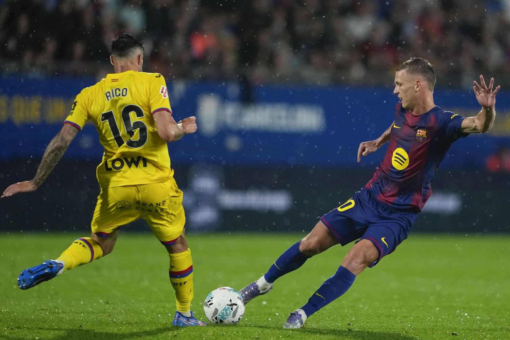 Barcelona forward Dani Olmo (R) fights for the ball against Getafe's Diego Rico during their LaLiga soccer match played at Johan Cruyff stadium in Barcelona, Spain on 21 September 2025. EFE/Alejandro Garcia