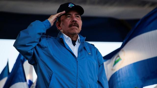Nicaraguan President Daniel Ortega sings the national anthem during a march called "We walk for peace and life. Justice" in Managua, Nicaragua