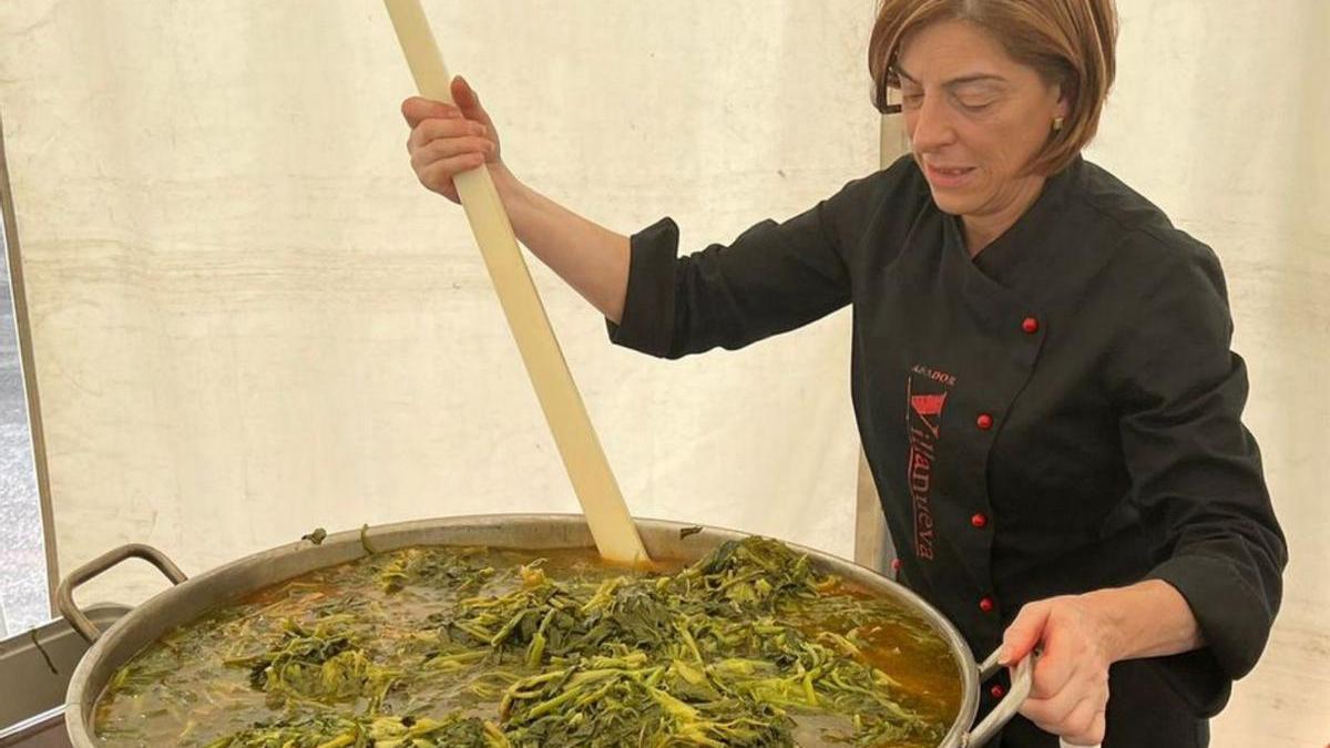 Una de las cocineras cociendo los quinientos kilos de grelos / f. once