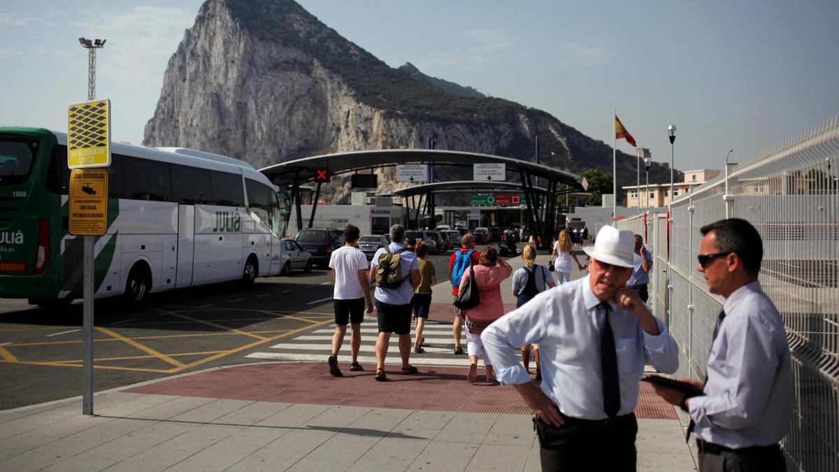 People enter the British territory of Gibraltar at its border with Spain, in La Linea de la Concepcion