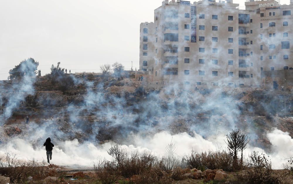 Israeli forces fire teargas canisters during a ...