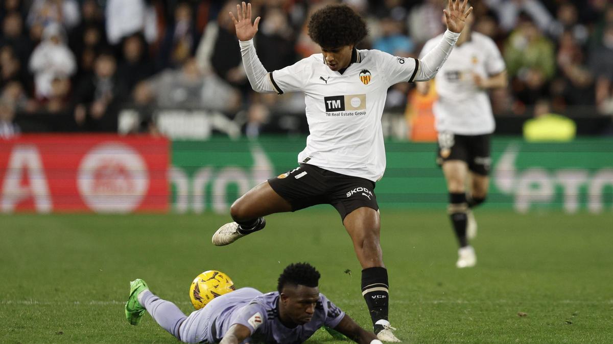 Peter Federico, jugador del Valencia cedido en el Real Madrid, disputa un balón con Vinicius en Mestalla.