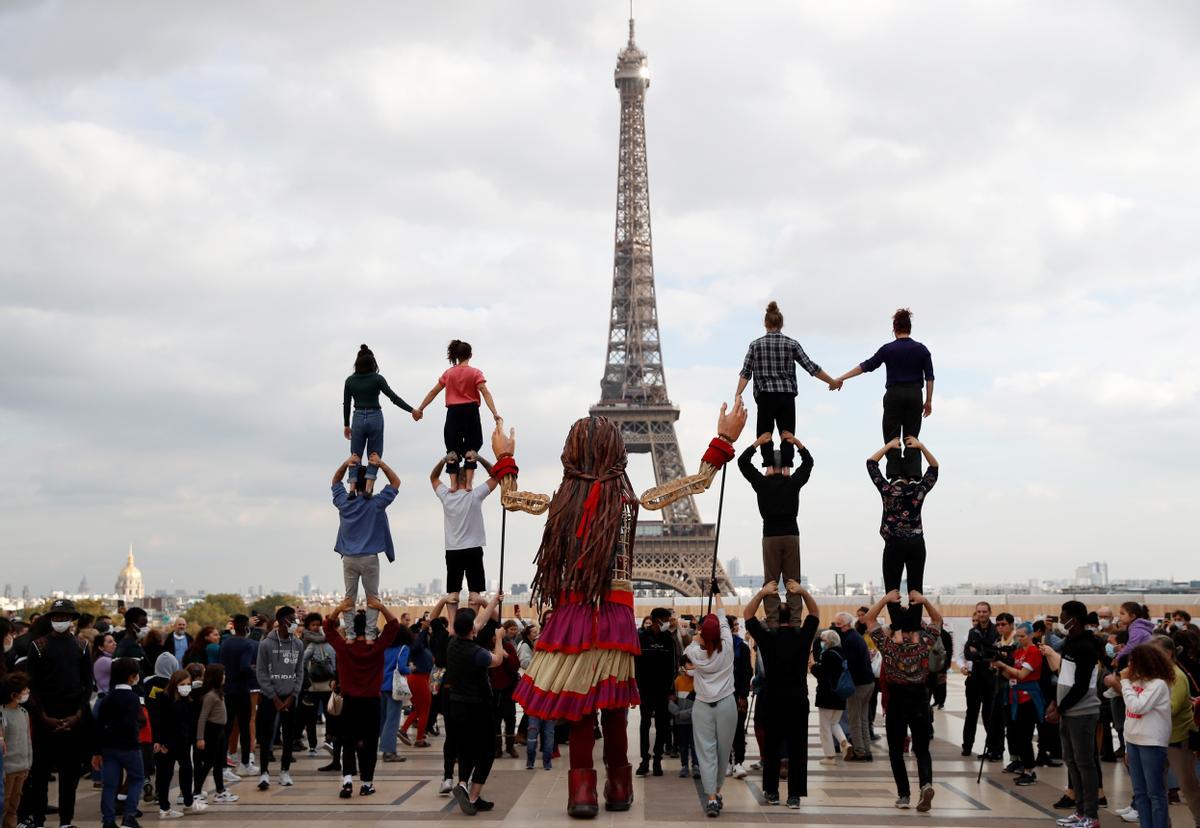 Fiesta alrededor de Little Amal en la plaza Trocadero, cerca de la torre Eiffel en París, Francia, 15 de octubre de 2021.