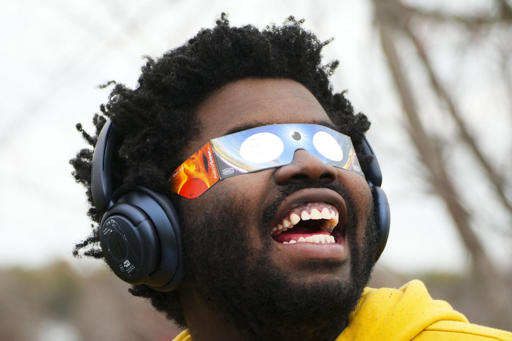 Didier Timothy-Mondesir watches the solar eclipse from Prince Edward County, Ontario, Monday, April 8, 2024. (Sean Kilpatrick/The Canadian Press via AP) / MANDATORY CREDIT