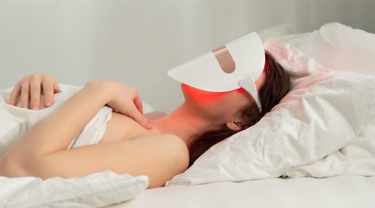 Mujer con máscara de tratamiento facial con luz LED
