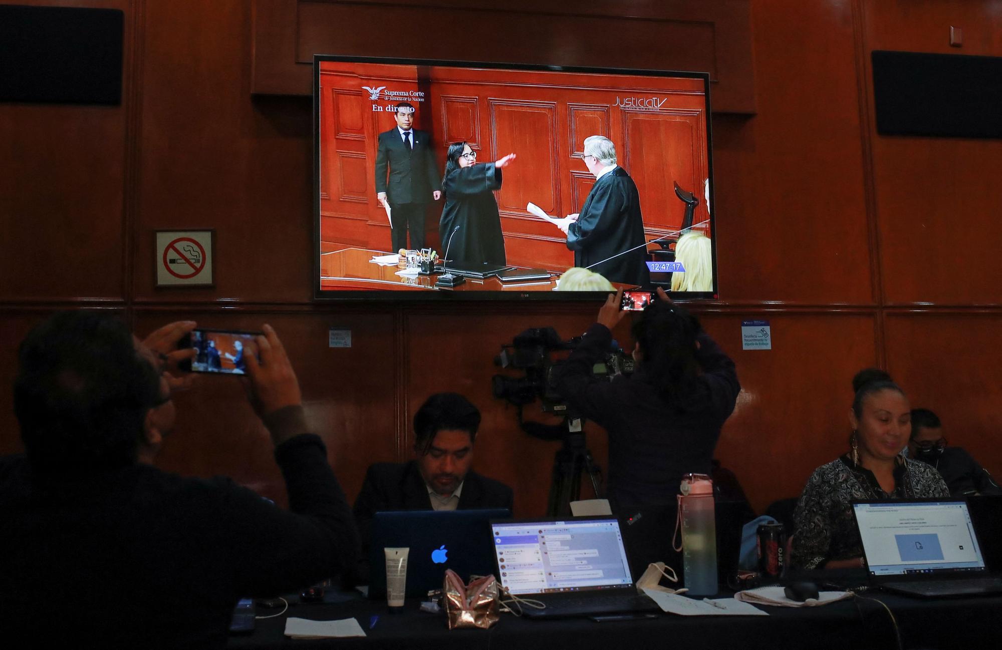 A screen shows Minister Norma Lucia Pina Hernandez taking the oath as president of the Supreme Court of Justice while speaking on a television screen in the press room of the Supreme Court building in Mexico City, Mexico January 2.