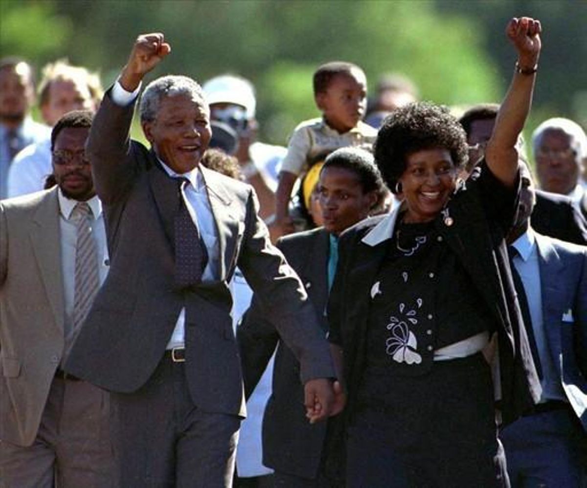 Nelson Mandela, accompanied by his wife Winnie, walks out of the Victor Verster prison near Cape Town after spending 27 years in apartheid jails in this February 11, 1990 file photo.