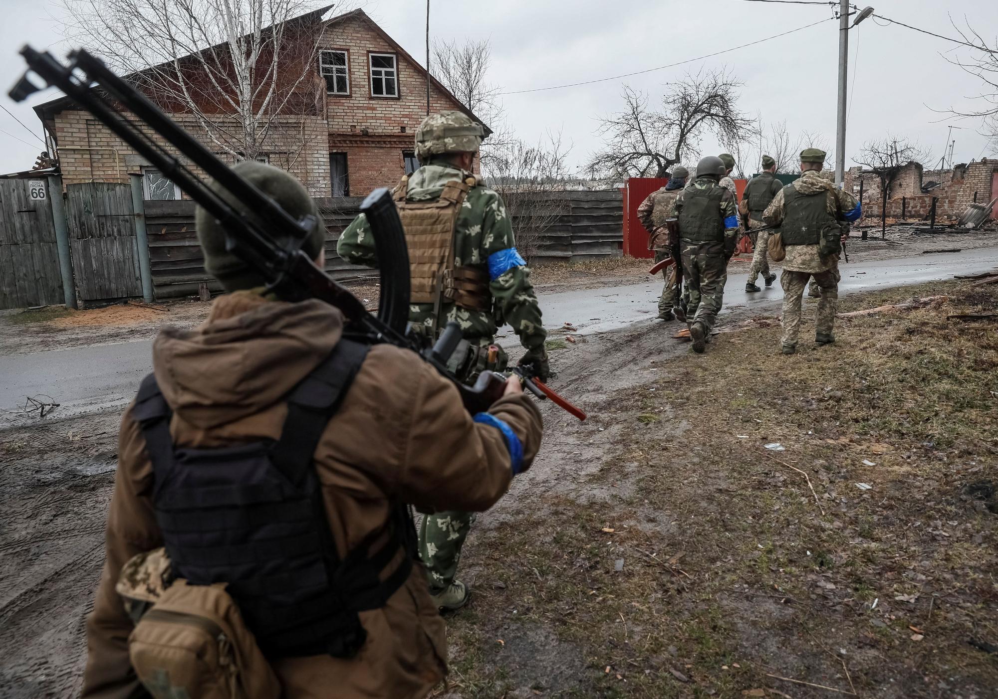 A Ukrainian service member walks on the front line near Kyiv