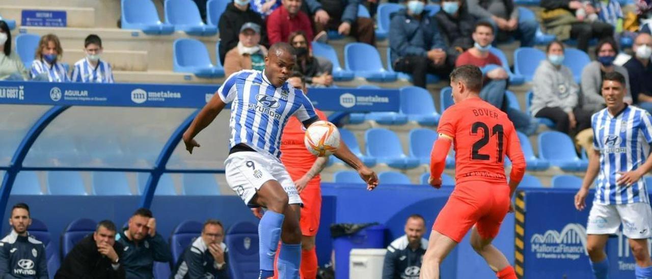 Vinicius controla ante la presión de Bover.