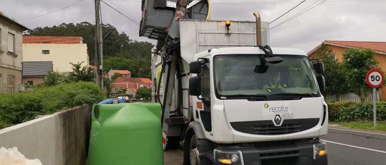 Un camión de la concesionaria de la basura recogiendo los residuos en Tirán. // Santos Álvarez