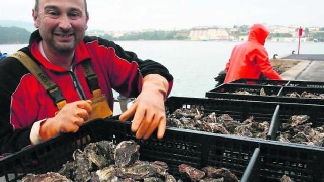 El biólogo Eduardo Martín trabajando, ayer, en la retirada del molusco de las aguas del Eo.