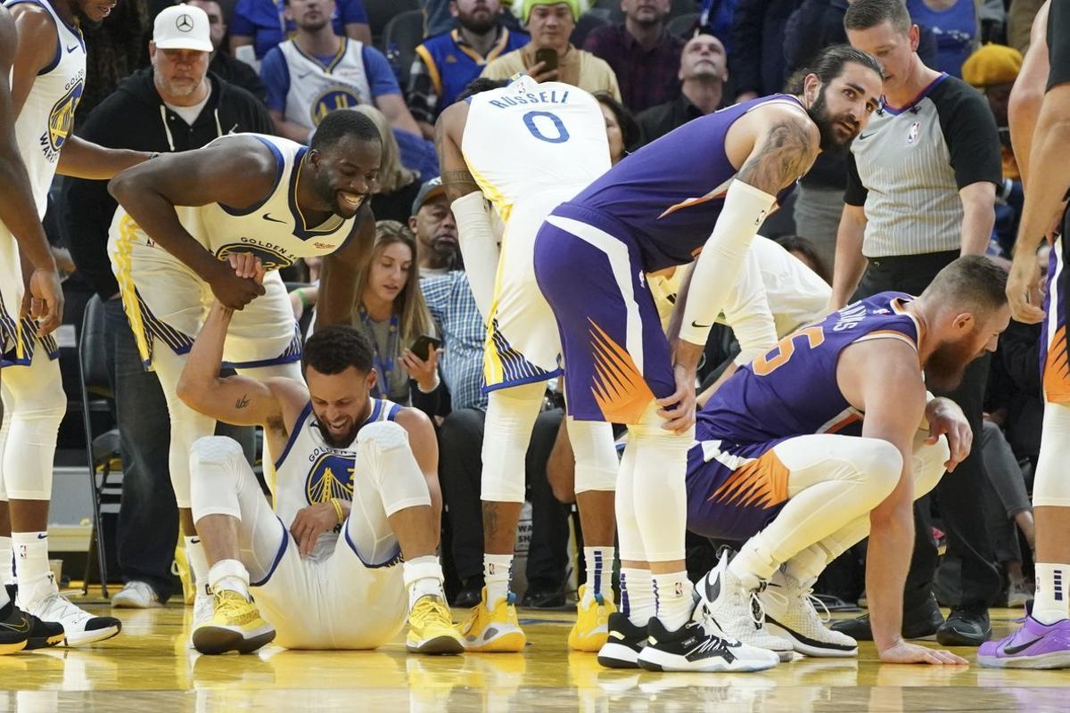October 30, 2019; San Francisco, CA, USA; Golden State Warriors forward Draymond Green (23) helps up guard Stephen Curry (30) after an injury during the third quarter against the Phoenix Suns at Chase Center. Mandatory Credit: Kyle Terada-USA TODAY Sports