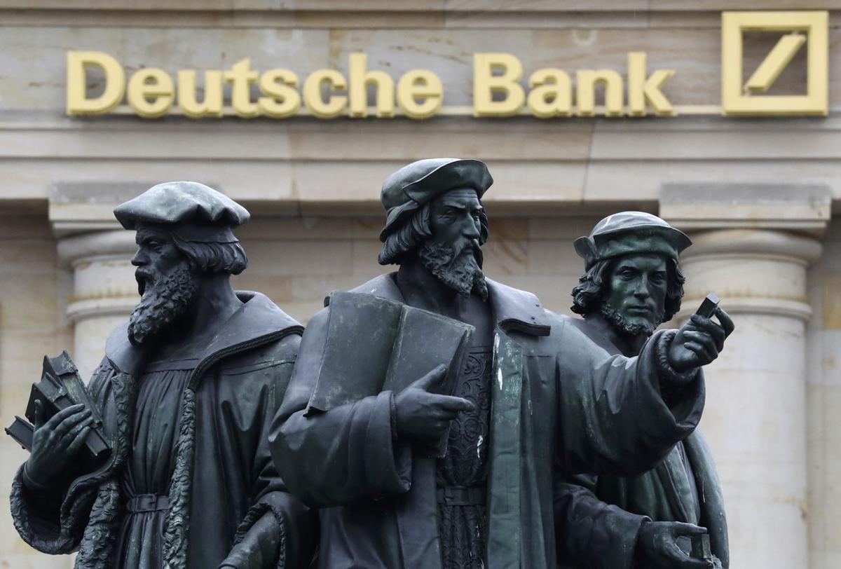 A statue is pictured next to the logo of Germany’s Deutsche Bank in Frankfurt, Germany, September 30, 2016. REUTERS/Kai Pfaffenbach
